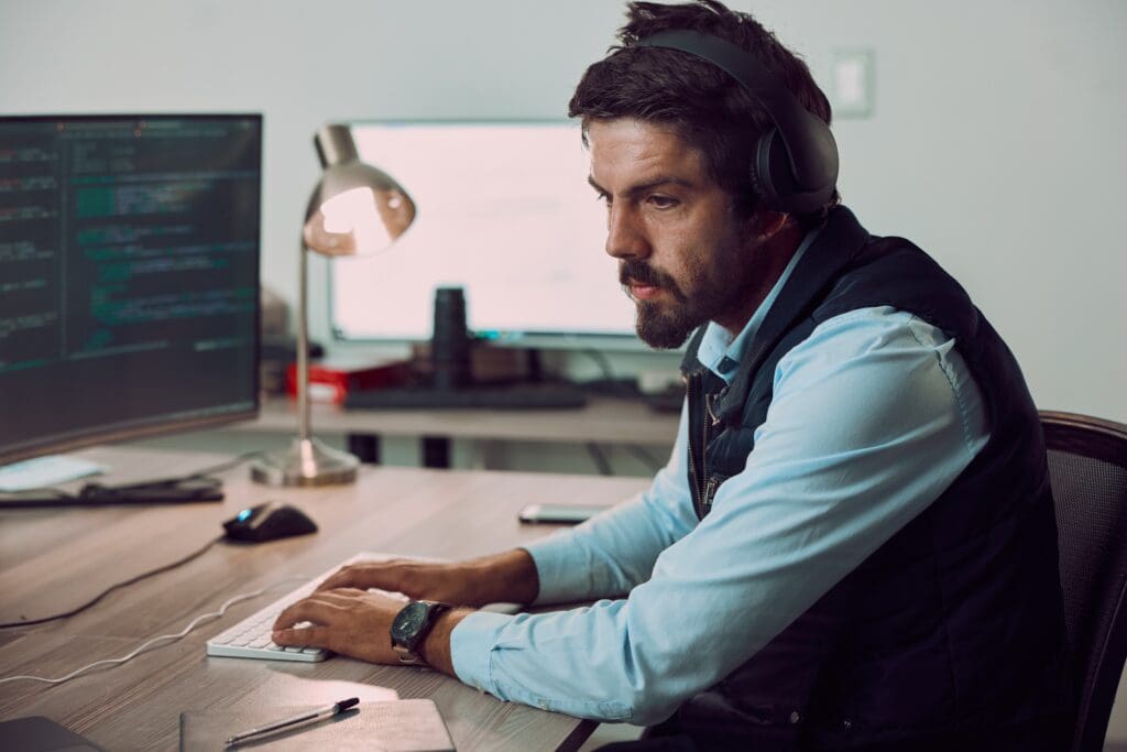 Headphones,,Programmer,And,Man,Typing,On,Computer,,Coding,Or,Programming